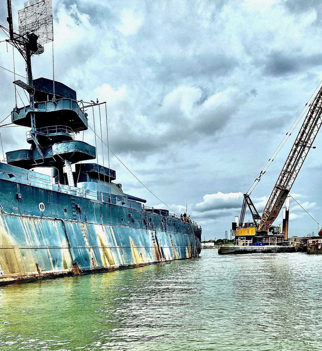 Dredging beside a historic battleship